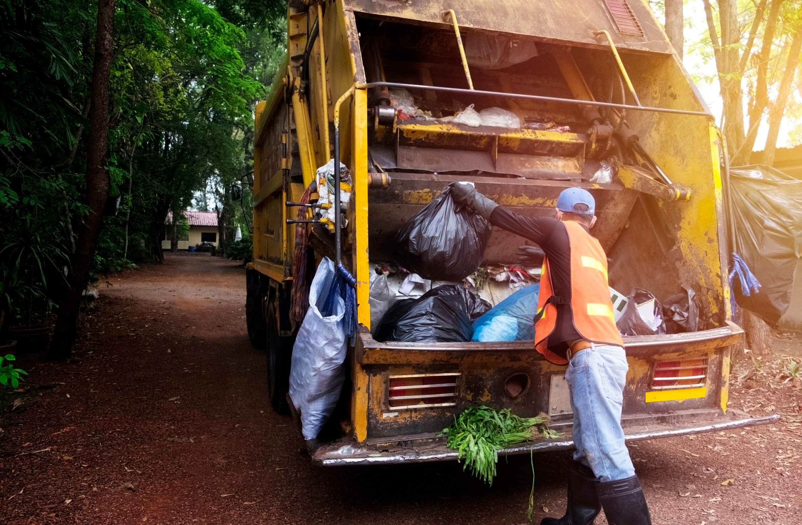 Workers collect garbage with garbage collection truck