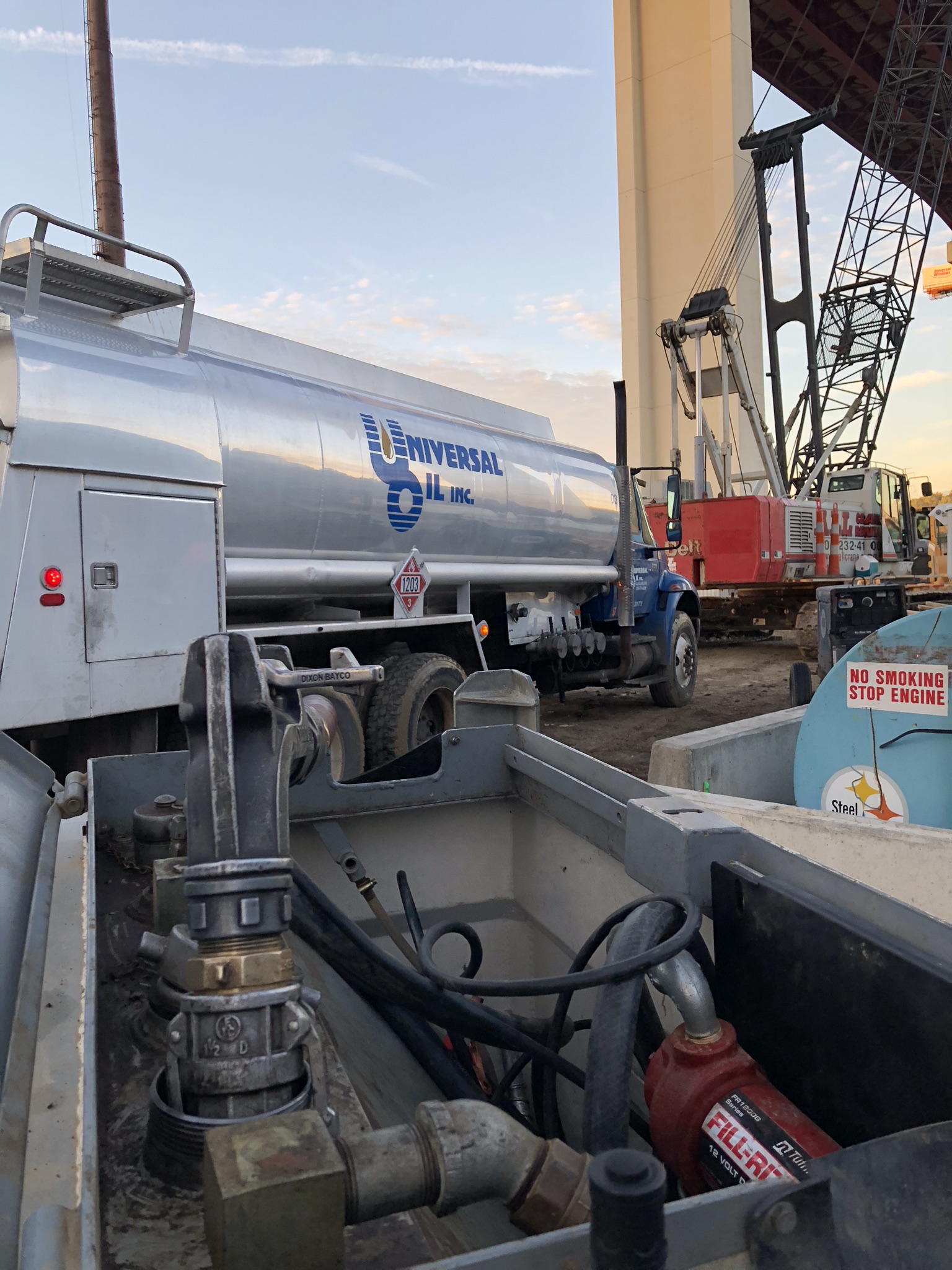 Image of a Universal Oil tanker truck filling a Universal Oil fuel tank