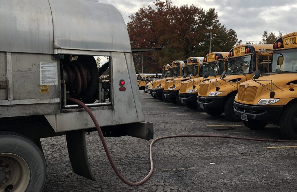 Image of a tank wethosing a fleet of school buses