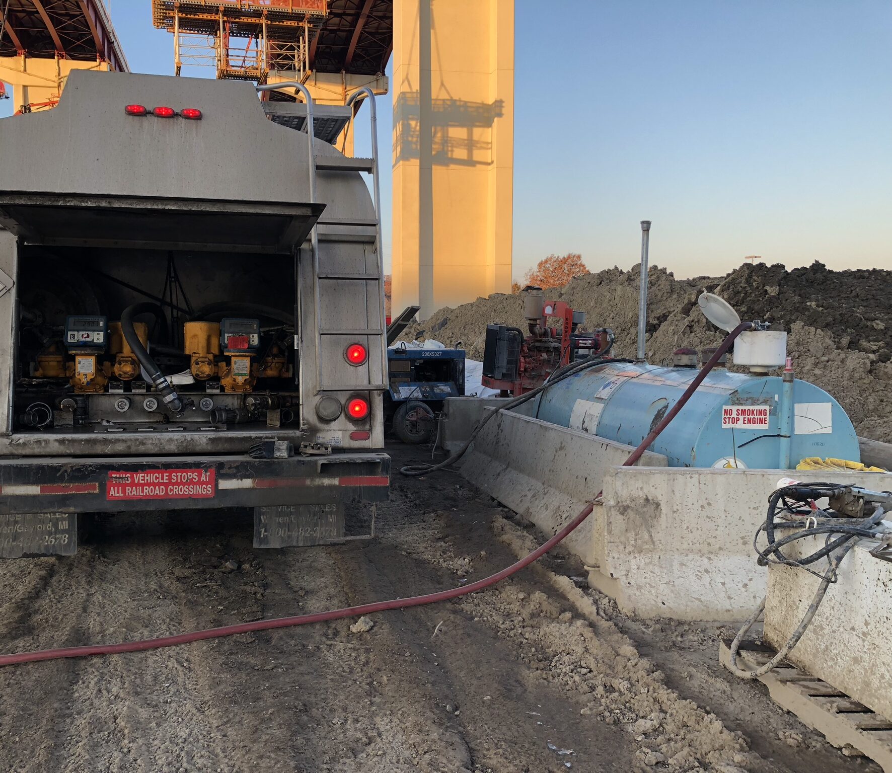 Image of a Universal Oil truck filling a Universal Oil fuel tank