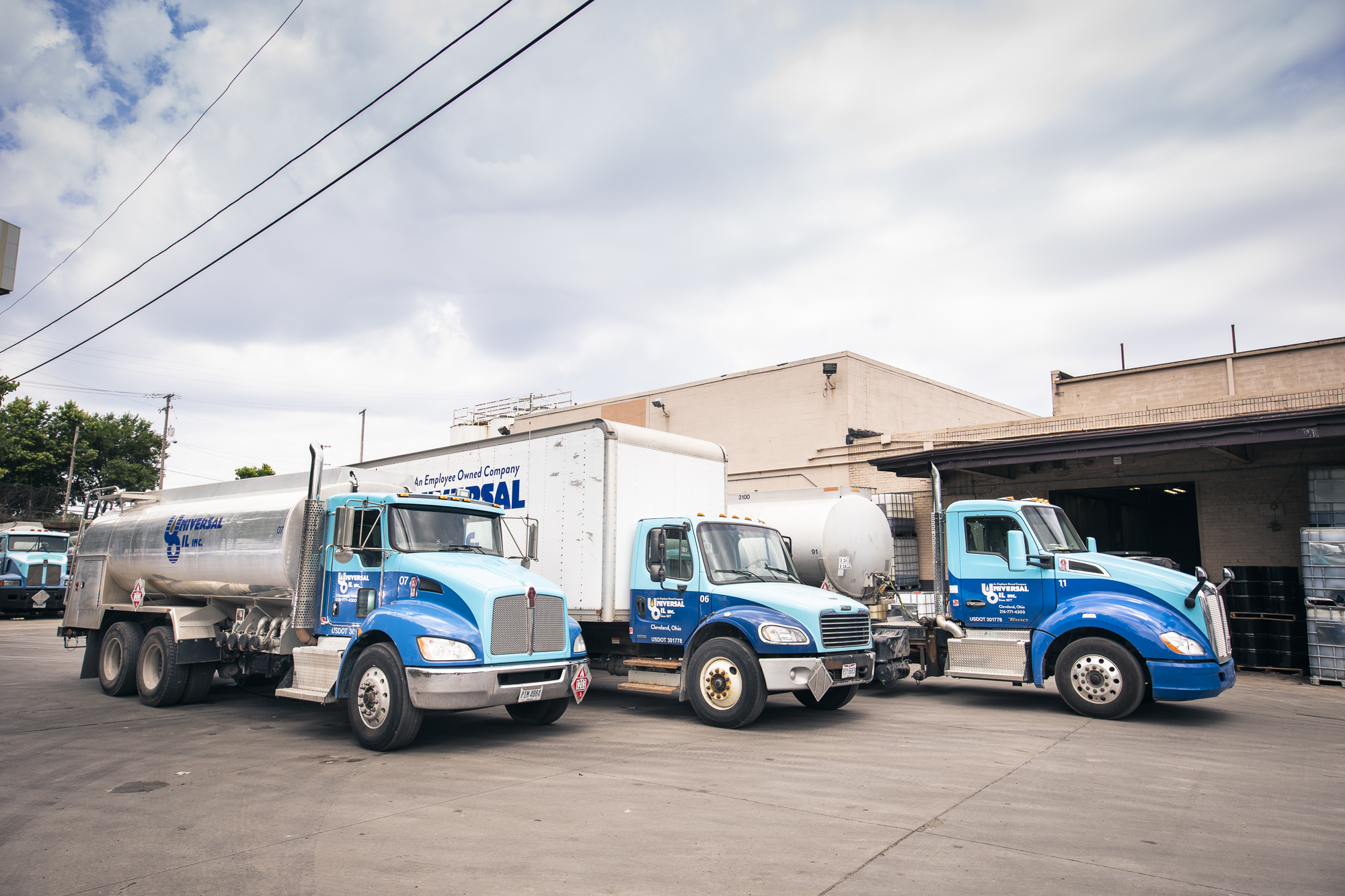 Image of several Universal Oil trucks in front of one of our buildings